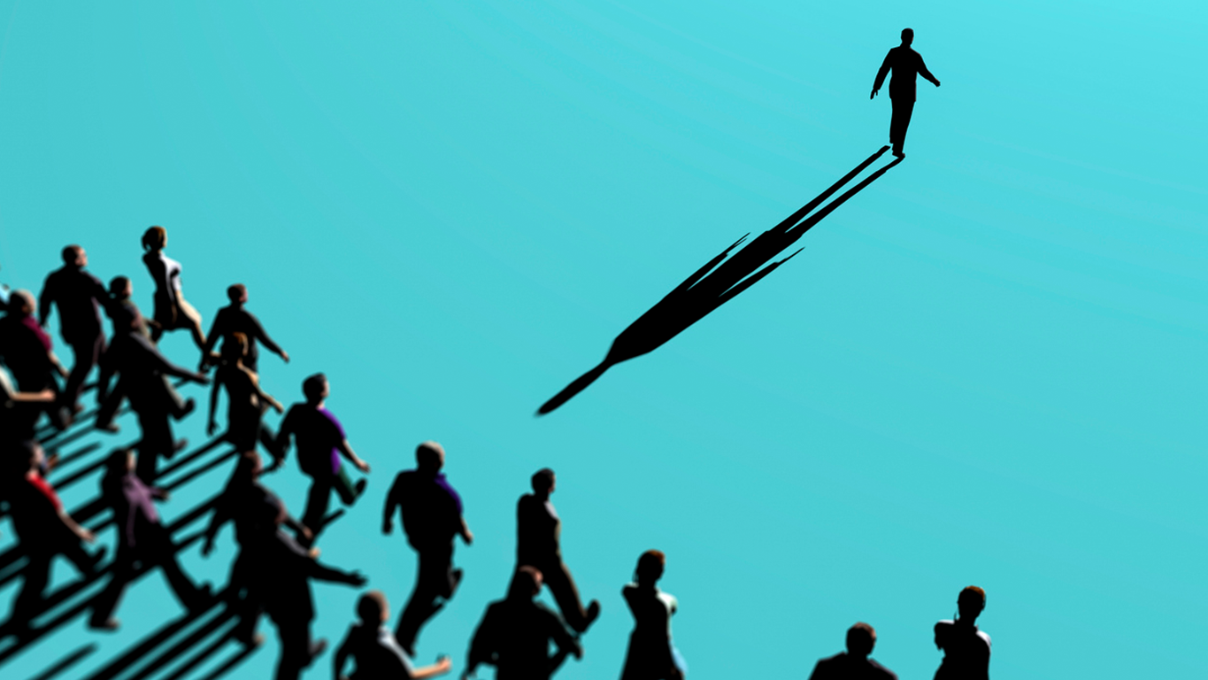 Silhouette of a single leader walking ahead while a crowd follows behind, symbolising leadership guiding organisations through AI transformation and change.